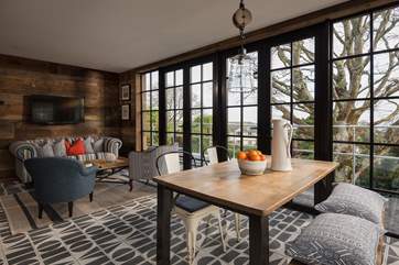 The fabulous open plan living space with walls of windows making the most of the amazing view.