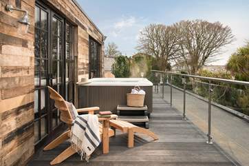 Relax on your private deck in or out of the steaming hot tub.