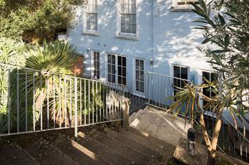 Steps lead down to the courtyard and front door.