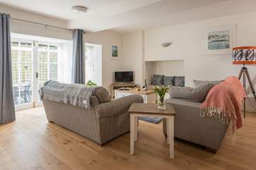 The spacious open plan living-room has two big sofas for stretching out on.