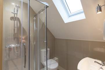 The en suite shower-room is filled with light from the Velux window.
