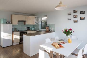 The dining-area is neatly positioned next to the kitchen. Perfect for serving up any meal.