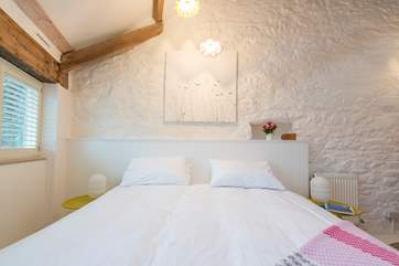 The bedroom is light and airy.