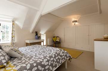 This bedroom overlooks the cottage's own hidden courtyard garden.