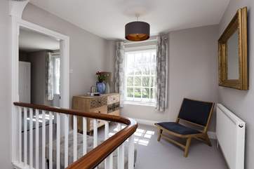 The first floor landing is a 'room' in its own right. The master bedroom is through the door to the left. The family shower room is on the half-landing before the final stairs to this lovely open ar