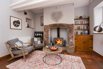 There is a welcoming informal seating area at one end of the large open plan kitchen area. There is a sofa for this lovely space too