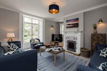 There is light-filled sitting room with a wood-burning stove and floor to ceiling doors to the terrace.