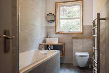 The family bathroom has a bath with fitted shower over.
