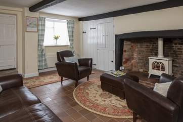 The cosy sitting-room has the original inglenook fireplace with a wood-burner effect gas stove, the thatch does not allow for an open fire.