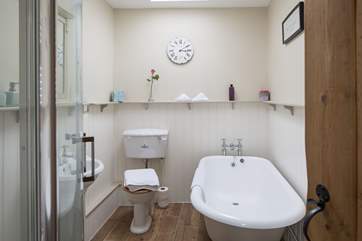 The luxurious bathroom is on the ground floor with roll-top bath and separate shower cubicle.