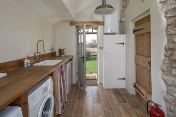 The spacious boot/utility-room leads in from the rear garden of the cottage.