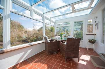 The sunny sun-room looks out over the garden.