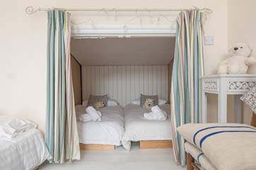 The family room offers this gorgeous little snug area sleeping two. What a great little den for one (or two) of the smaller members of the party.