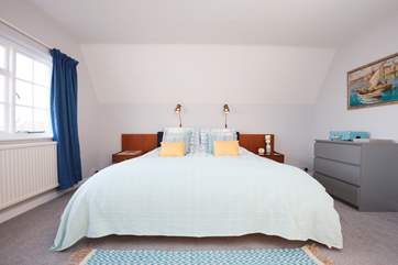 The spacious master bedroom with super king-size bed over looks the garden