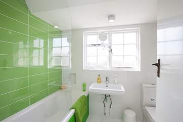 First floor bathroom with fitted shower is certainly colourful.