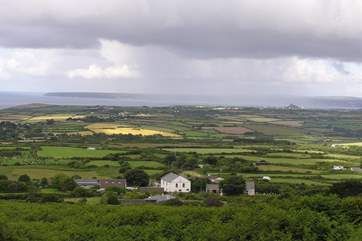 Taken from the path up Tregonning Hill, Mazey's Cottage is in the centre of the photo (beyond the chapel and surrounded by trees and fields).