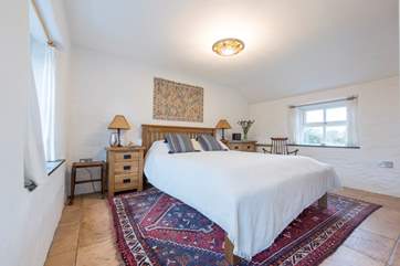 The master bedroom houses a king-size bed.