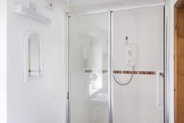 The en suite shower-room, with a small step leading into the shower (approx. 13 inches).
