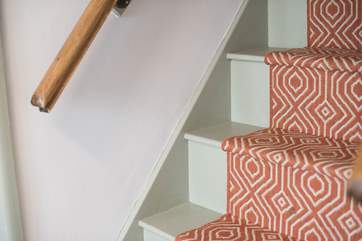 Steep cottage stairs lead up to the bedrooms.
