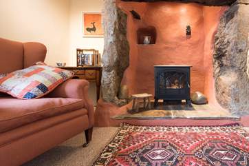Relax in the comfortable sitting-room, where the electric stove provides a focal point.