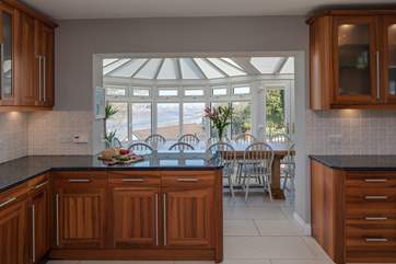 The kitchen leads into the dining-area where a huge dining-table, with the most delightful views await.