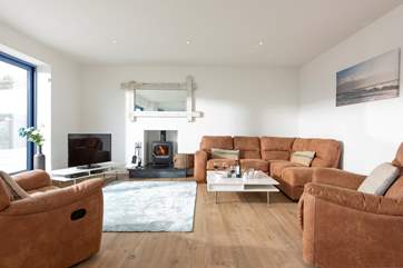 The sitting-area with the roaring wood-burner at the far end.