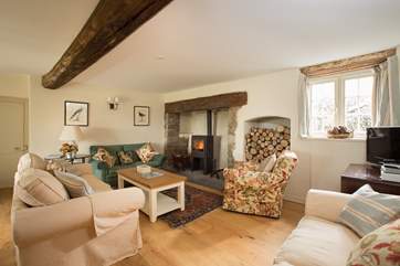 The sitting-room with its wood-burning stove is at the heart of the house. There is plenty of comfortable seating for you all to relax.