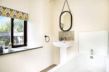 Relax and enjoy a soak in the family bathroom.