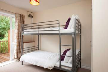 Just beyond the bunk room is a decked patio to the rear of the cottage.