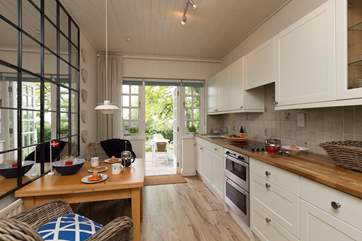 The kitchen is bright and has a wonderful contemporary feel, with a door directly out to the terrace above the gardens.