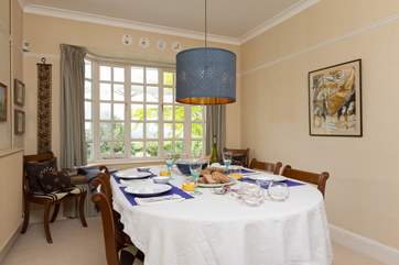 The dining-room is between the kitchen and sitting-room and has a lovely outlook over the garden.