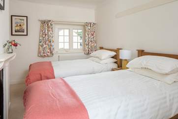 The cheerful twin room looks over the village square at the front and the garden at the back.