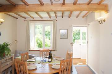 The dining room is bright and sunny, with a stable door so that you can bring the outside in