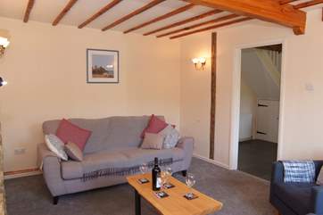 A second image of the living room with the dining room beyond.