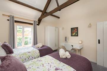 The twin bedroom has an outlook over the fields above the cottage on the other side of the road