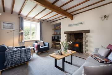There is a lovely cosy sitting room with wood burner effect electric stove and character beams.