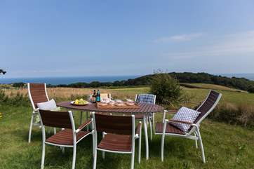 The lawned rear garden has open views across countryside to the sea.