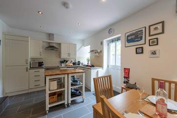 The kitchen/dining-area with an island in the middle.