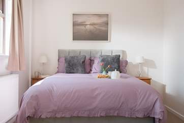 The master bedroom has lovely calm tones.