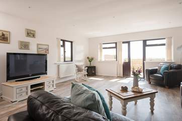 The patio doors open to a terrace with far reaching views over the football/golf course.