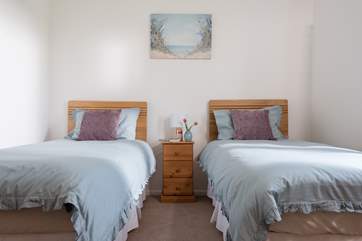 This bedroom is very charming with plenty of storage.