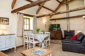 The large sitting/dining-room has a wonderful sense of space thanks to the vaulted ceiling.