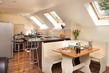 Or inside you can have your meals at the breakfast-bar or the dining-table.