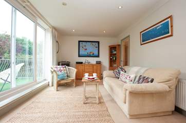 The sitting-room is spacious, light and comfortable