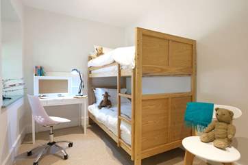 Children will love the touches in the bunk bedroom.