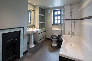 The family bathroom boasts a lovingly restored fireplace. What a stunning piece of history.