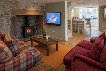 Looking through to the kitchen, past the Bang & Olufsen TV. No expense has been spared in this beautiful cottage.