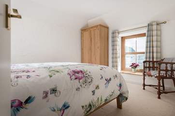 The bed is perfectly positioned for gazing out into the garden.