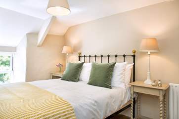 Gorgeous linens and Atlantic Blanket throws adorn the bed.
