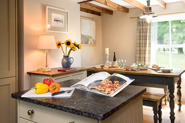 The moveable island divides the kitchen from the dining-area.